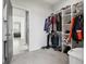 Walk-in closet with extensive organization, including shelves, drawers, and an easy entrance to the bathroom at 1180 Antelope W Dr, Bennett, CO 80102