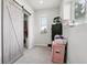 Bright closet with barn door and shelving for storage at 1180 Antelope W Dr, Bennett, CO 80102