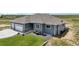 Stunning exterior showcasing professional landscaping, stone accents, and spacious three-car garage at 1180 Antelope W Dr, Bennett, CO 80102