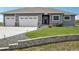 Charming one-story home with a three car garage, landscaped yard, and stone accents at 1180 Antelope W Dr, Bennett, CO 80102