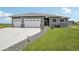 One-story home with three-car garage, dark trim, landscaping, and stone accents at 1180 Antelope W Dr, Bennett, CO 80102