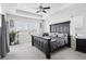 A spacious main bedroom showcases tray ceilings, carpeted floors, and bright windows for natural light at 1180 Antelope W Dr, Bennett, CO 80102