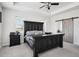This main bedroom features tray ceilings and a modern barn door leading to an en-suite bathroom at 1180 Antelope W Dr, Bennett, CO 80102
