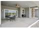 Covered patio with ceiling fan, grill, and dining area overlooking the landscape at 1180 Antelope W Dr, Bennett, CO 80102