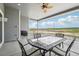 Covered patio dining and grill area with views of the surrounding landscape at 1180 Antelope W Dr, Bennett, CO 80102