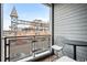 Cozy balcony features metal railing, seating, and views of the neighborhood buildings at 2706 Blake St, Denver, CO 80205