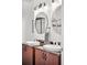 Bathroom featuring dual sinks with granite countertops, modern lighting, and a separate glass-enclosed shower at 2706 Blake St, Denver, CO 80205