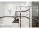 Bright bathroom featuring a glass-enclosed shower and a soaking tub with modern fixtures and tiled accents at 2706 Blake St, Denver, CO 80205