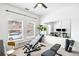 Brightly lit home gym features weights, equipment and natural light from the room's two windows at 2706 Blake St, Denver, CO 80205