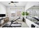 Brightly lit home gym with large mirrors, workout equipment, natural light, and a modern ceiling fan at 2706 Blake St, Denver, CO 80205