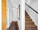 Hallway featuring a staircase, decorative rug, and a light-filled ambiance with access to other rooms at 2706 Blake St, Denver, CO 80205