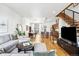 Bright and airy living room features modern decor, hardwood floors, and an open floor plan leading to the kitchen at 2706 Blake St, Denver, CO 80205