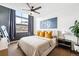 Bright main bedroom with statement art, side table, and city views at 2706 Blake St, Denver, CO 80205