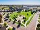 Aerial view of a park featuring lush green space, playground, walking paths, and surrounded by homes at 973 Treece St, Louisville, CO 80027