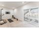 Versatile basement space with workout equipment, access to the outdoors, and natural light, ideal for fitness at 973 Treece St, Louisville, CO 80027