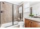 Tiled bathroom with glass enclosed shower, neutral walls, and stylish fixtures at 973 Treece St, Louisville, CO 80027