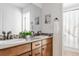 Charming bathroom with dual sinks, wood cabinets, and decorative accents at 973 Treece St, Louisville, CO 80027