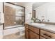 Stylish bathroom featuring a shower-tub combination, vanity with wood cabinets, and modern fixtures for a sleek design at 973 Treece St, Louisville, CO 80027