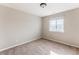 Neutral-toned bedroom with carpet, white trim, and a single window at 973 Treece St, Louisville, CO 80027