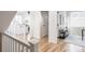 Inviting hallway with natural light, showcasing hardwood floors, white trim, and an open view to the living area at 973 Treece St, Louisville, CO 80027