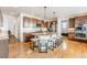 Spacious kitchen featuring an island with seating, stainless appliances, and wooden cabinets at 973 Treece St, Louisville, CO 80027