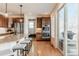 Kitchen featuring double ovens, a kitchen island with seating and a sliding door to a patio at 973 Treece St, Louisville, CO 80027