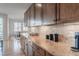 Kitchen featuring gorgeous stone countertops, stunning wooden cabinets and modern appliances at 973 Treece St, Louisville, CO 80027