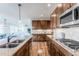 Kitchen featuring stainless steel appliances, gorgeous countertops and warm wood cabinets at 973 Treece St, Louisville, CO 80027