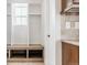 Mudroom featuring storage, coat hooks, bench seating, and access to the kitchen at 973 Treece St, Louisville, CO 80027