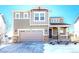 Two-story house with gray siding, stone accents, and a two-car garage at 27192 E Frost Pl, Aurora, CO 80016