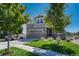 Two-story house with gray siding, stone accents, and a landscaped front yard at 27192 E Frost Pl, Aurora, CO 80016