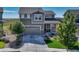 Two-story house with gray siding, stone accents, and a two-car garage at 27192 E Frost Pl, Aurora, CO 80016