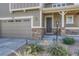 Front entrance with stone accents and a covered porch at 27192 E Frost Pl, Aurora, CO 80016