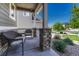 Covered porch with wicker furniture, offering a relaxing outdoor space at 27192 E Frost Pl, Aurora, CO 80016