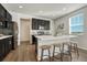 Modern kitchen with dark cabinetry, quartz countertops, and island at 27192 E Frost Pl, Aurora, CO 80016