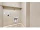 Bright laundry room with built-in shelving and space for a washer and dryer at 27192 E Frost Pl, Aurora, CO 80016