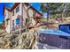Home exterior featuring a relaxing hot tub area and mature trees on a hilltop at 2433 Dogie Spur, Golden, CO 80403