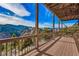 Scenic view from a wooden deck overlooking mountains and lush greenery on a bright day at 2433 Dogie Spur, Golden, CO 80403