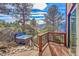 Outdoor deck with hot tub, wooded views, and a relaxing atmosphere at 2433 Dogie Spur, Golden, CO 80403