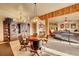 Dining room with wooden table, chairs and chandelier, and a large bookshelf on the back wall at 2433 Dogie Spur, Golden, CO 80403