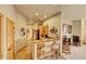 Hallway with bar seating, tile floors, and cabinets, leading to other areas of the house at 2433 Dogie Spur, Golden, CO 80403