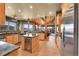 Gourmet kitchen features a wine fridge, stainless steel appliances, and mountain views at 2433 Dogie Spur, Golden, CO 80403