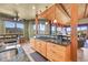 Kitchen with granite countertops, custom wood cabinets, cooktop, and outdoor views at 2433 Dogie Spur, Golden, CO 80403