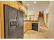Kitchen with black fridge and stairs leading to another floor visible through the kitchen layout at 2433 Dogie Spur, Golden, CO 80403