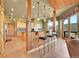 Open kitchen features a breakfast bar, wood beams, tile flooring, and outdoor views at 2433 Dogie Spur, Golden, CO 80403