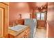 Charming laundry room with a farmhouse sink, washer, dryer and bright natural light from the window at 2433 Dogie Spur, Golden, CO 80403