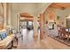 Open-concept living room with a stone fireplace and tile flooring at 2433 Dogie Spur, Golden, CO 80403