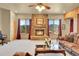 Open living room with a stone fireplace, plush sofa, and large windows with views of the mountains at 2433 Dogie Spur, Golden, CO 80403