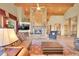 Cozy living room with a stone fireplace, perfect for relaxing and entertaining at 2433 Dogie Spur, Golden, CO 80403