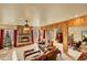 Cozy living room with a stone fireplace, plush seating, and natural light at 2433 Dogie Spur, Golden, CO 80403